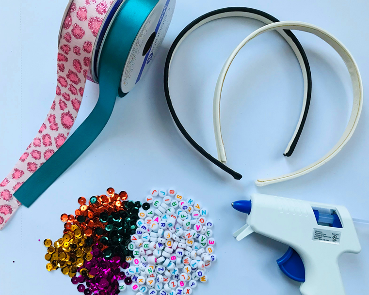 Project supplies: ribbon, beads, glue gun and hair accessory base.