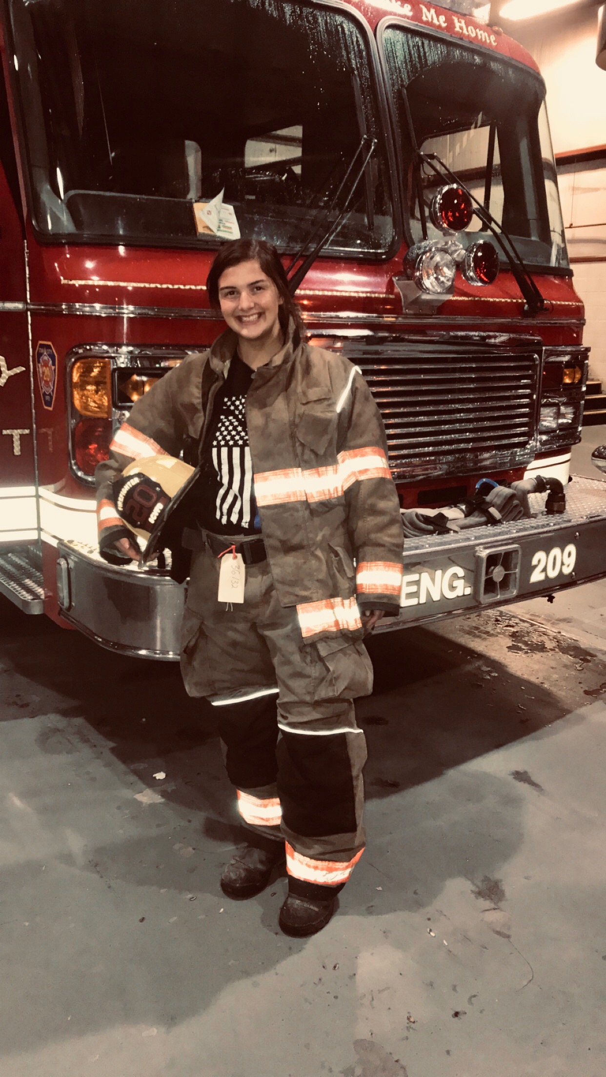 Abigail in firefighter uniform, showing the importance of serving your community.