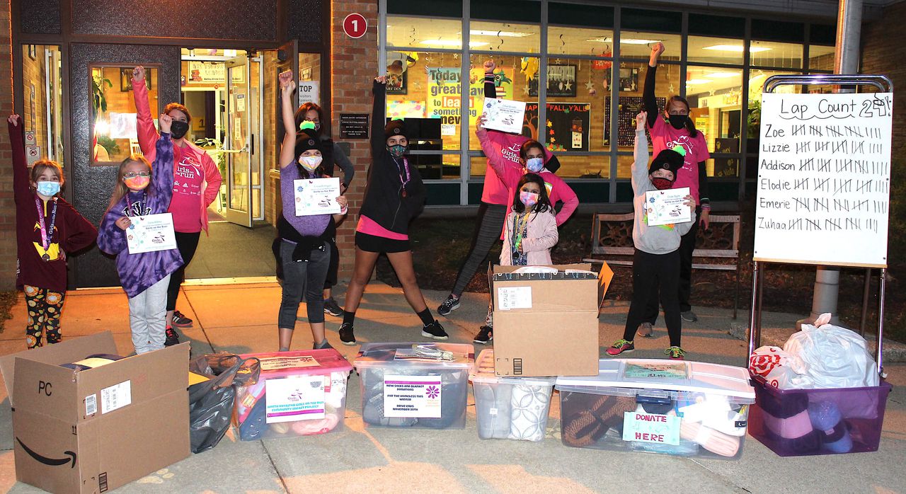 Girls and coaches donating socks and blankets to local shelter