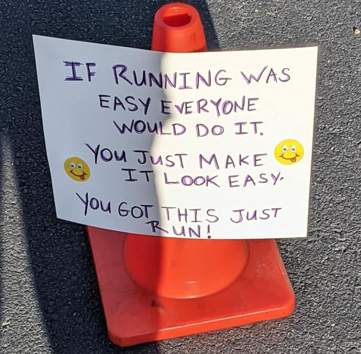 Fantastic 5K sign with purple writing on orange cone that says if running was easy everyone would do it. You just make it look easy. You got this just run!