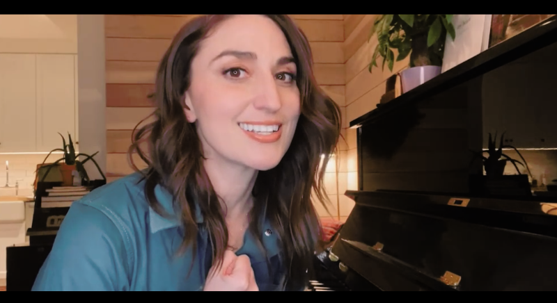 Women with brown hair smiling while seated at a piano