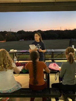 Coach Bri presenting a lesson to the team.