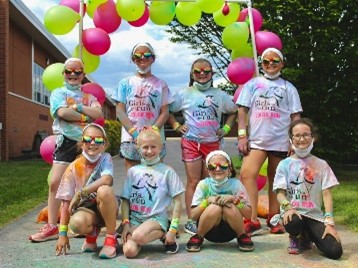 eight GOTR girls smiling at 5K event