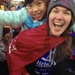 Coach and girl smiling at event