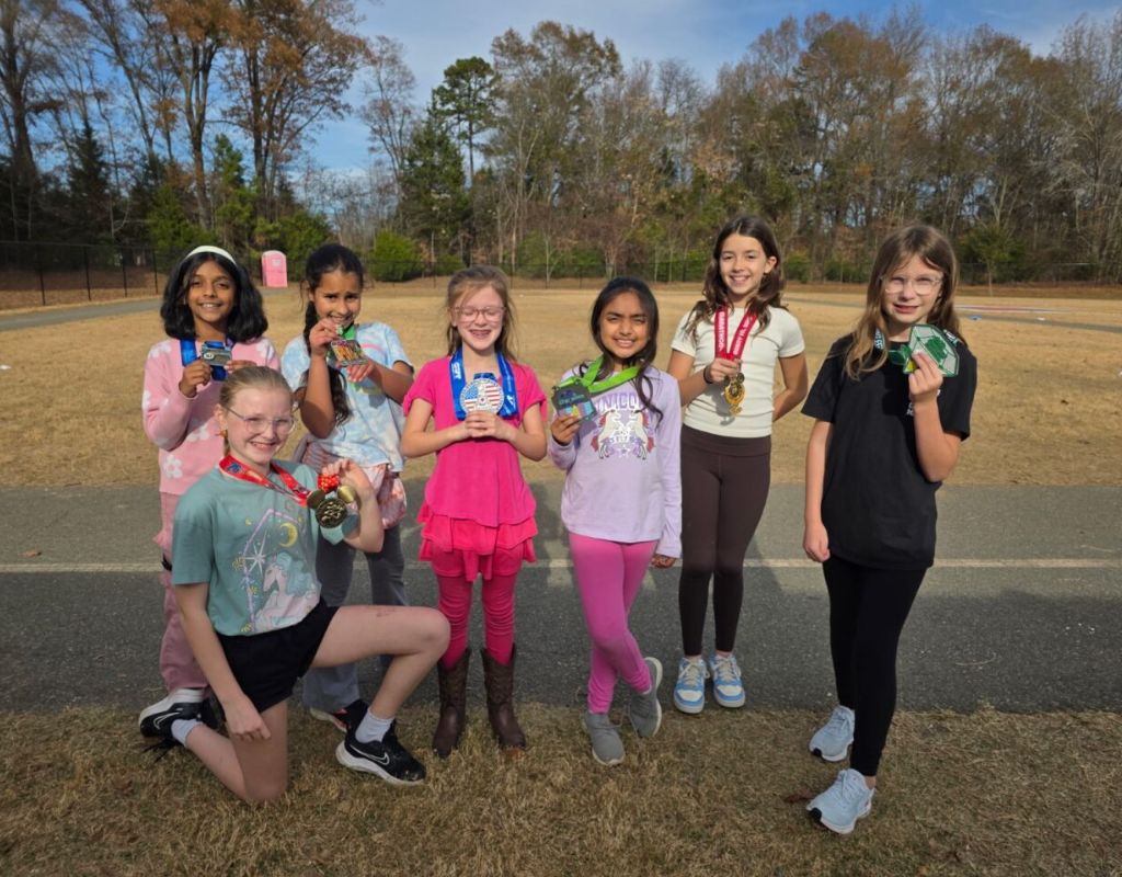 GOTR team posing with marathon medals.